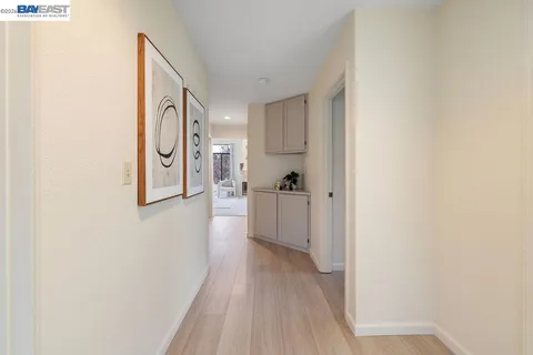 a view of a hallway with wooden floor