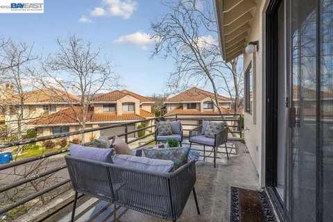 a view of a chairs and table on the balcony