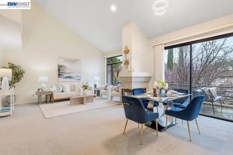 a living room with furniture and large windows