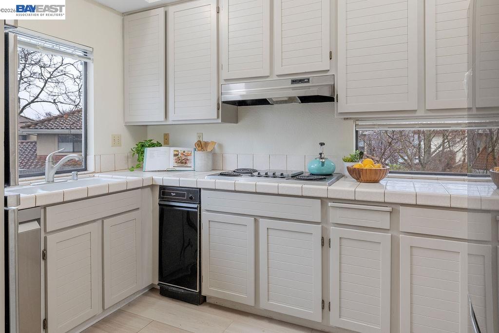 711 Lakemont Place, Unit 4 San Ramon, CA 94582 - Photo 6 of 28 a kitchen with white cabinets and a sink