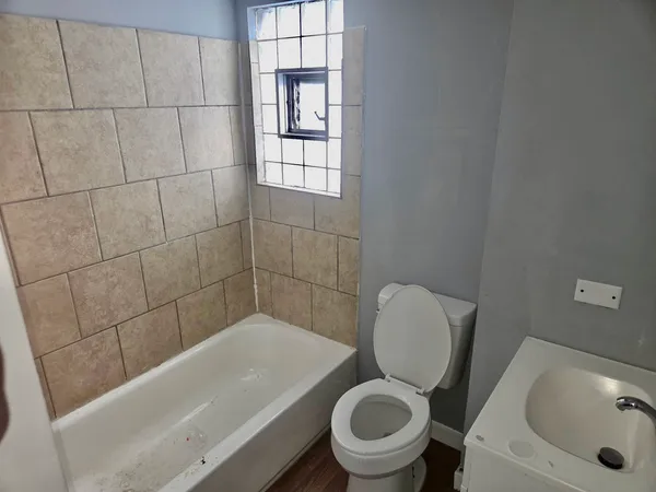 a bath room with a toilet and a sink