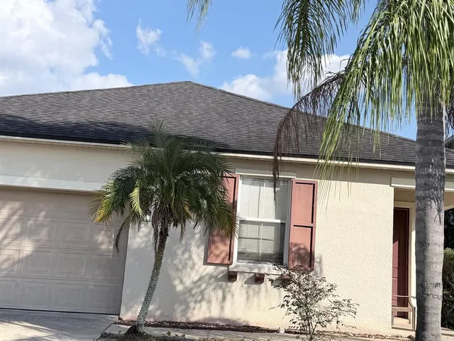 a backyard of a house with a fountain