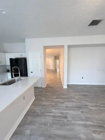 a view of a kitchen from the hallway