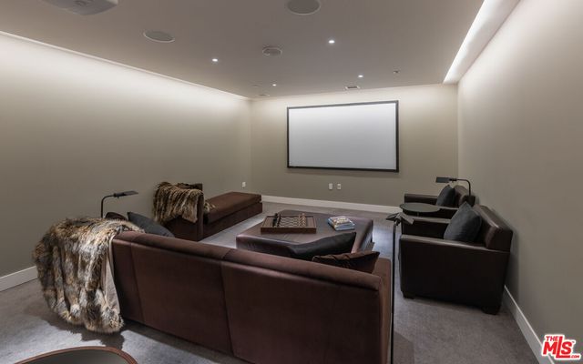 a room with furniture and a projector screen