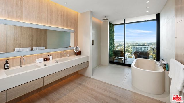 a large white bathroom with a large tub and shower