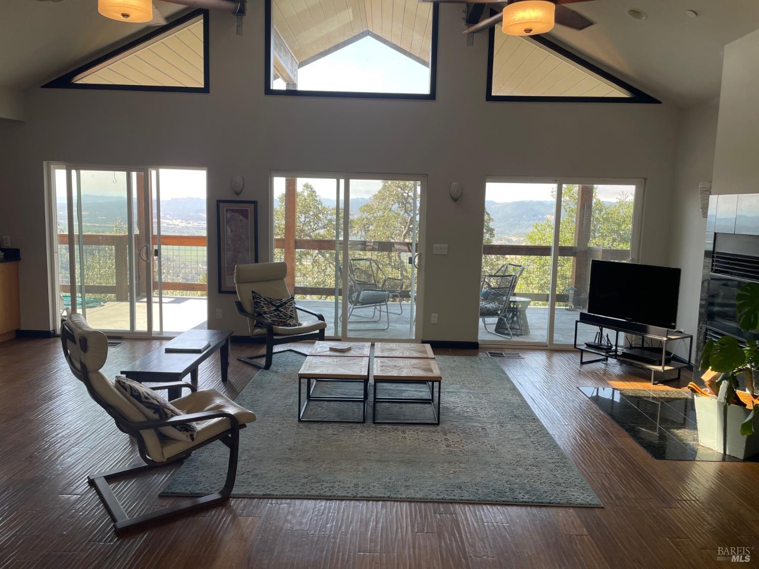 31000 Pine Mountain Road Cloverdale, CA 95425 - Photo 14 of 61 Spacious great room with wood-burning fireplace and seamless connection to the outdoor deck.