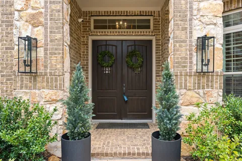 a front view of a house with plants