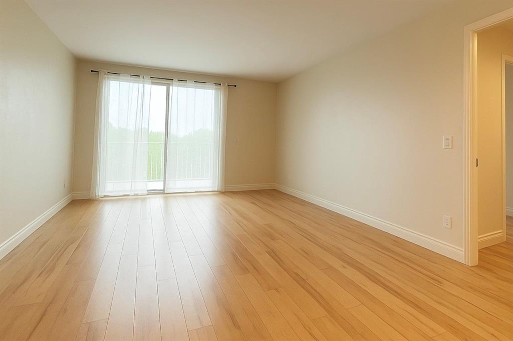 7280 Southwest 90th Street, Unit 304 Miami, FL 33156 - Photo 2 of 13 wooden floor in an empty room with a window