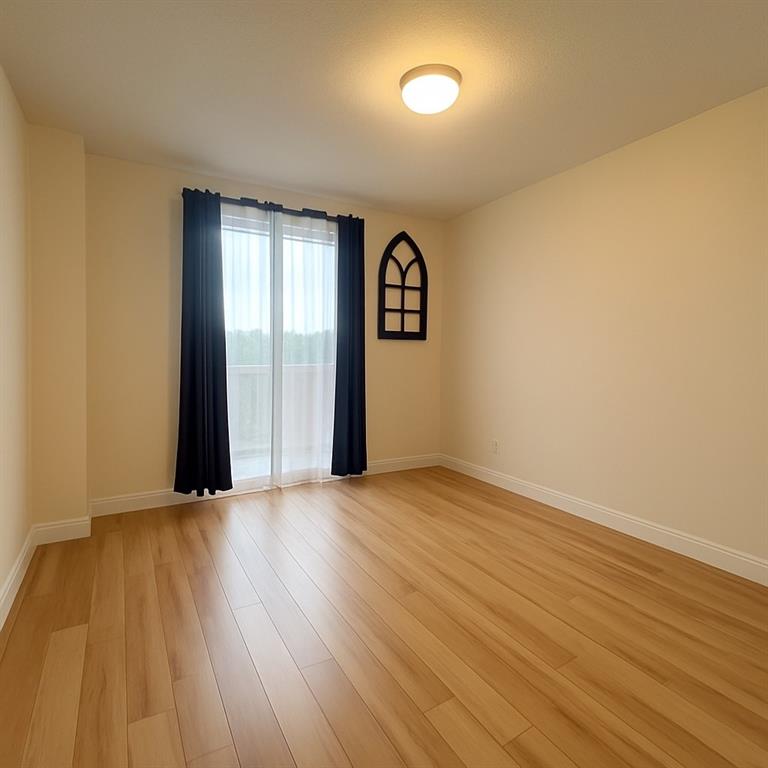7280 Southwest 90th Street, Unit 304 Miami, FL 33156 - Photo 4 of 13 an empty room with wooden floor and windows