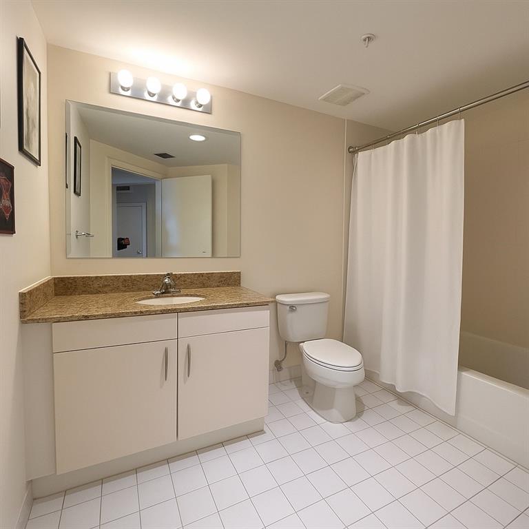 7280 Southwest 90th Street, Unit 304 Miami, FL 33156 - Photo 5 of 13 a bathroom with a granite countertop sink a toilet and a mirror
