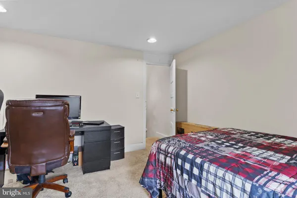 a bedroom with a bed and a desk