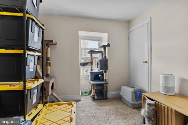 a view of room with guitars and refrigerator