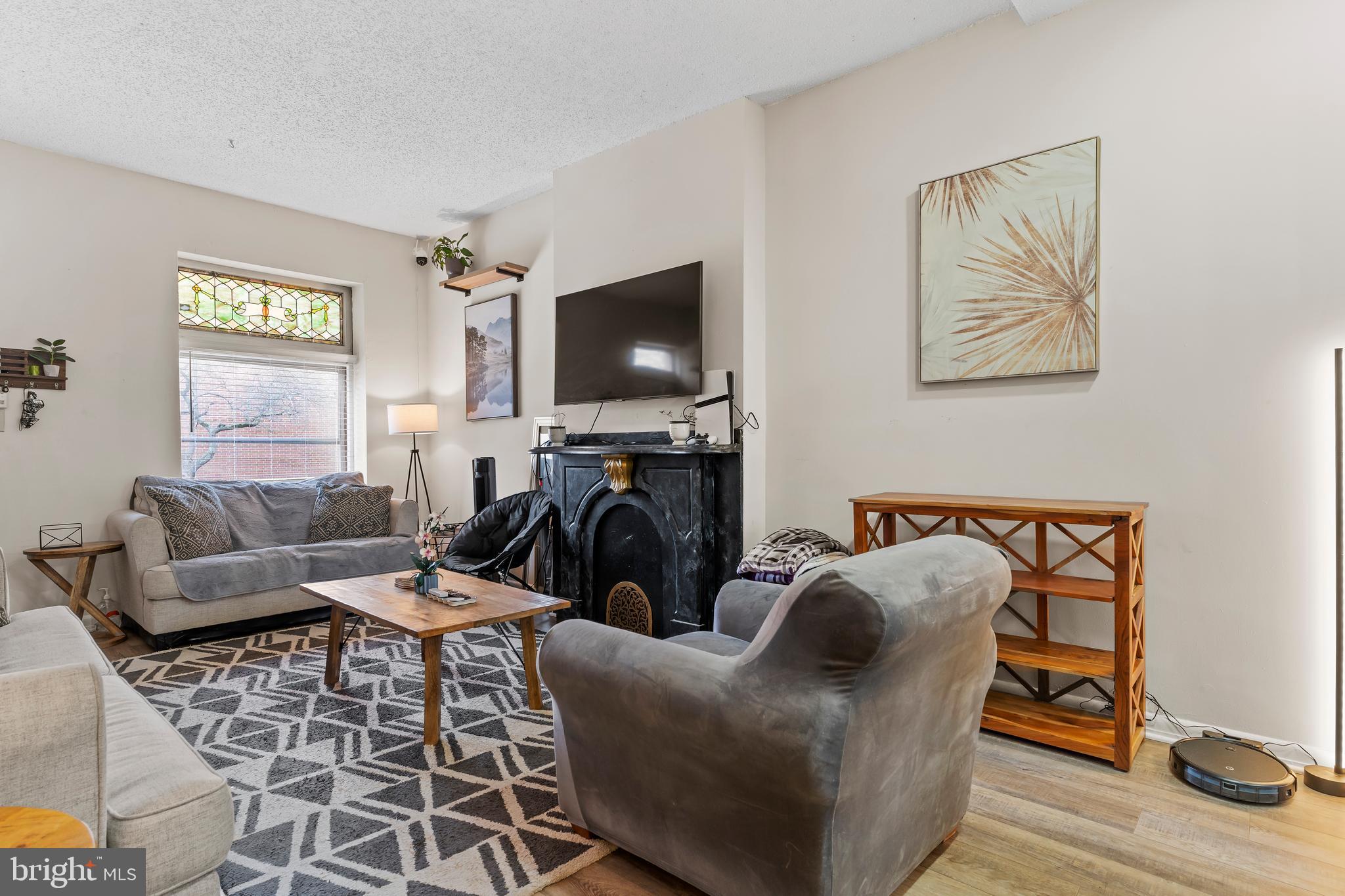 411 Herr Street Harrisburg, PA 17102 - Photo 2 of 18 a living room with furniture a flat screen tv and a window