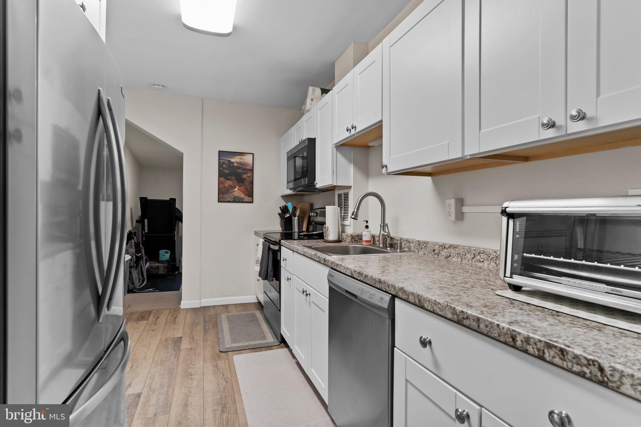 411 Herr Street Harrisburg, PA 17102 - Photo 6 of 18 a kitchen with stainless steel appliances granite countertop a refrigerator sink and stove