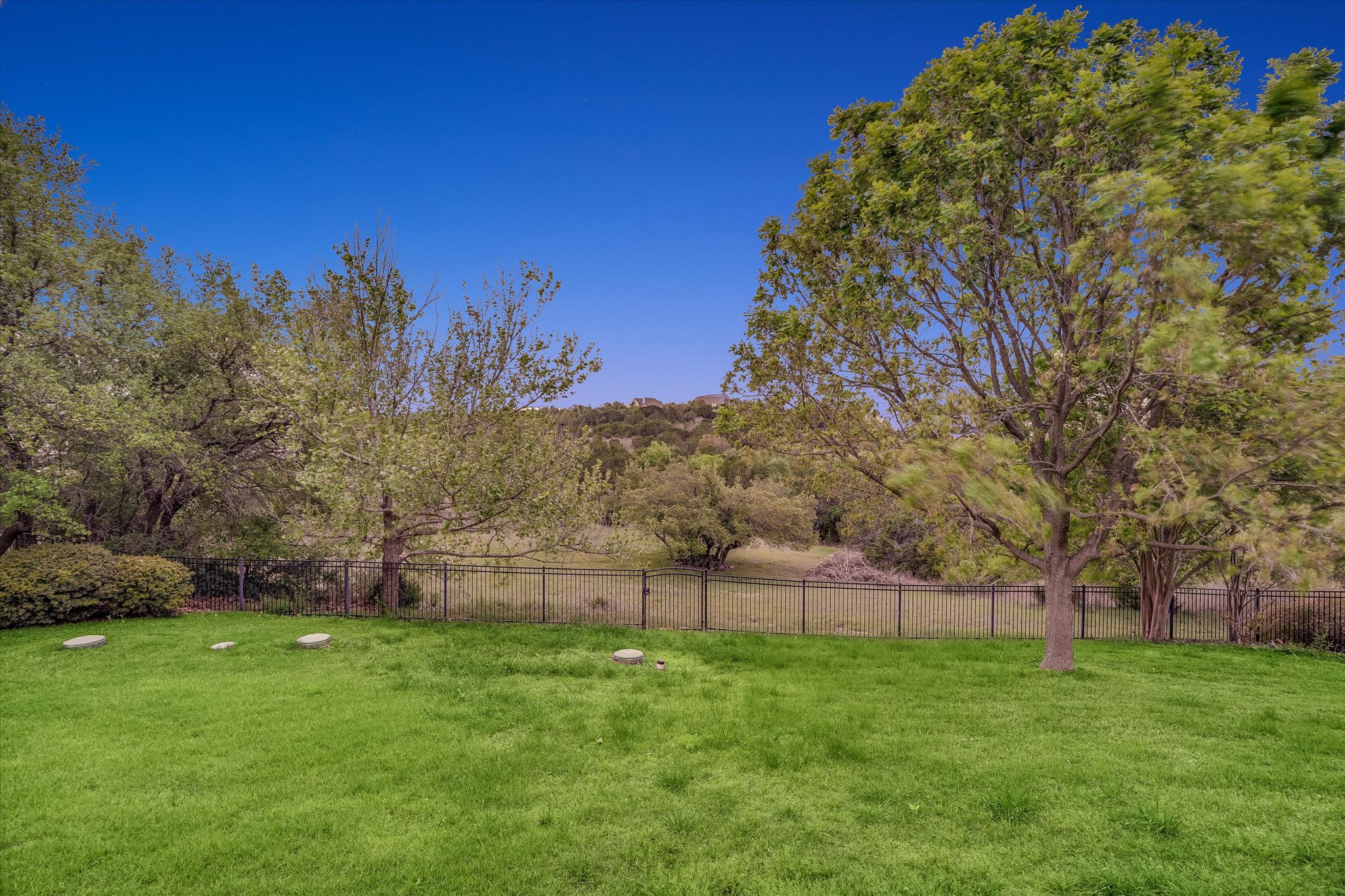 1400 Tom Sawyer Road Austin, TX 78737 - Photo 32 of 40 Spacious backyard with mature trees, fenced and lots of room to expand or add a pool.