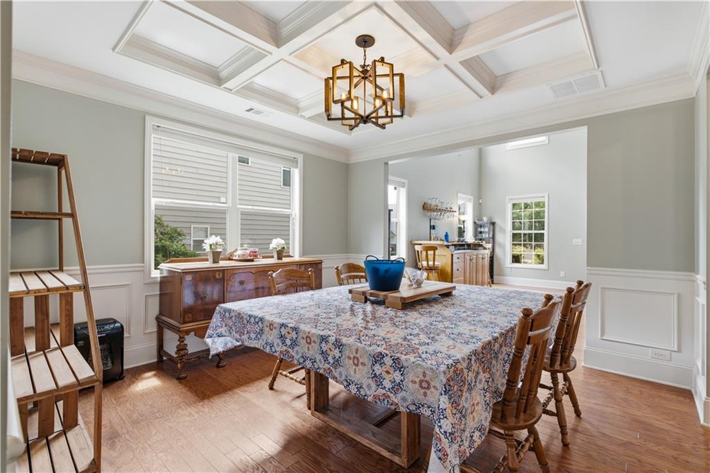 5825 Willow Oak Pass Cumming, GA 30040 - Photo 14 of 55 a view of a dining room with furniture window and wooden floor