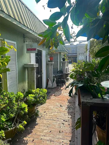 a view of a house with potted plants