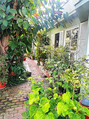 a view of a house with a flower garden
