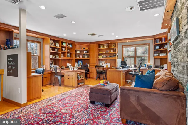 a living room with fireplace furniture and a rug