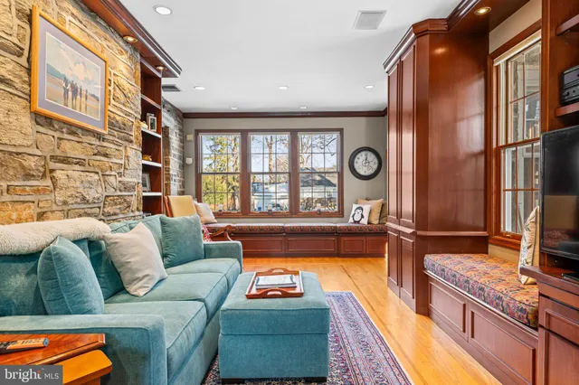 a dining room with furniture a chandelier and wooden floor