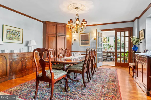 a kitchen with a table chairs stove and cabinets