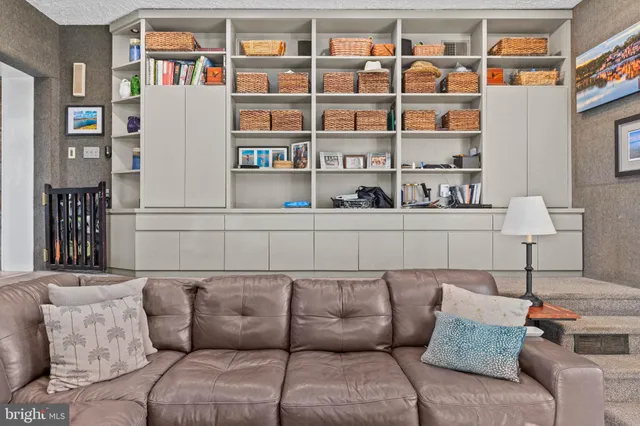 a living room with furniture and a dresser