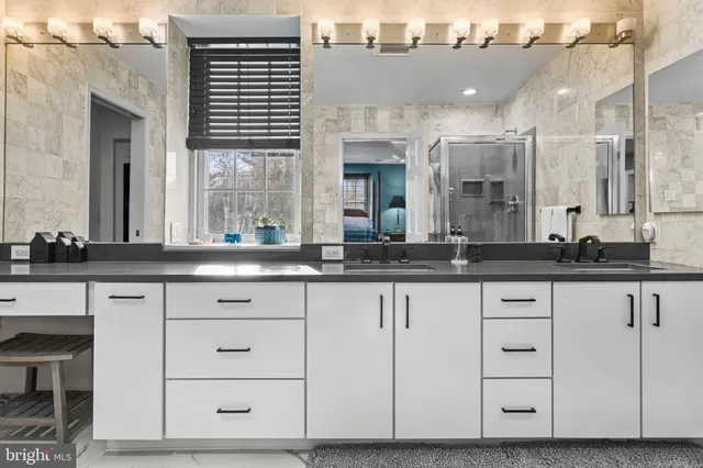 a bathroom with a toilet a sink and a large mirror