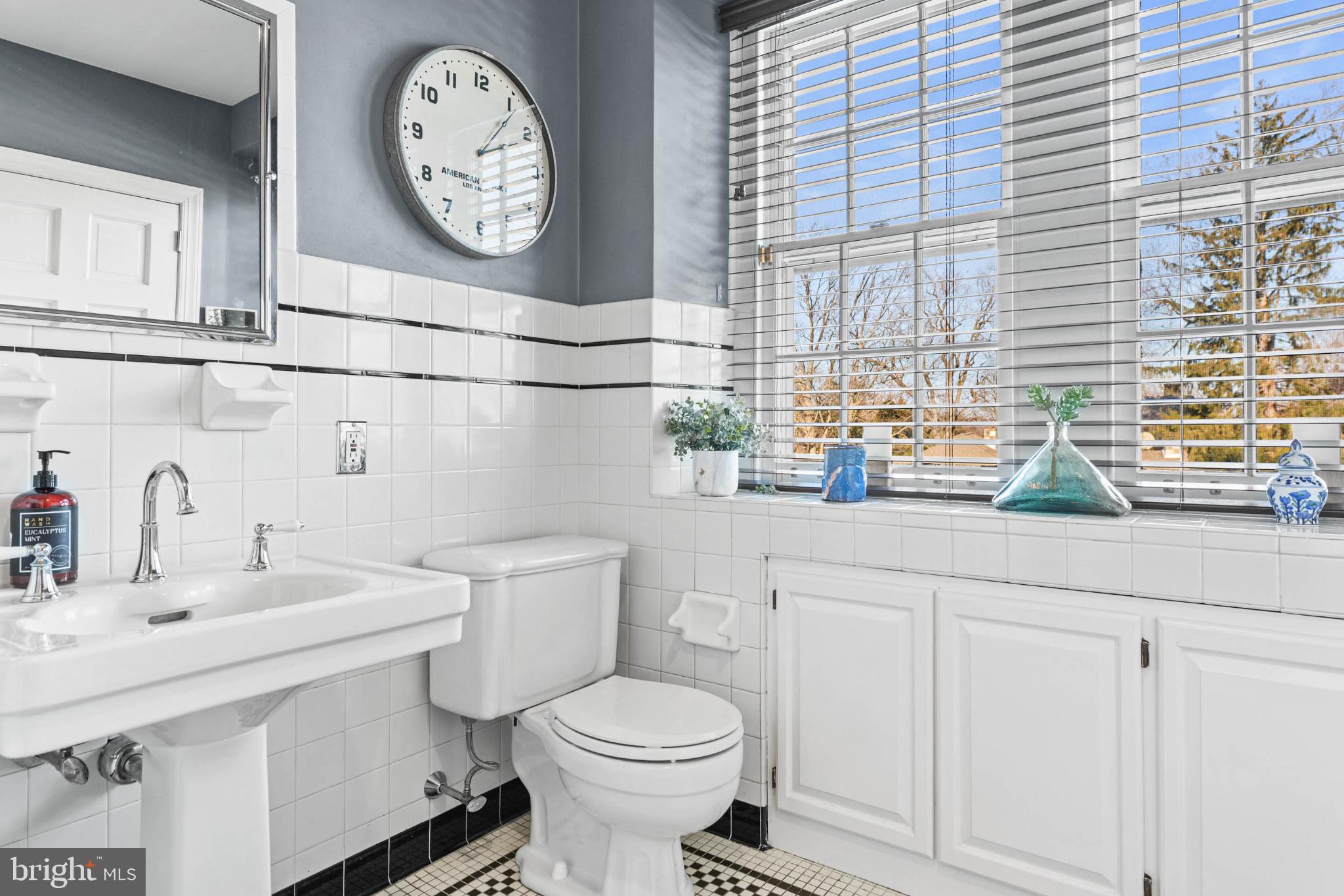 1432 Noble Road Rydal, PA 19046 - Photo 47 of 69 a bathroom with a toilet a sink and a large mirror