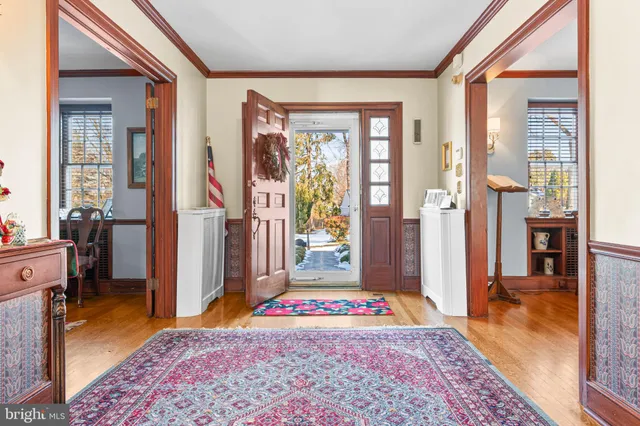 a view of an entryway with a rug front door and windows