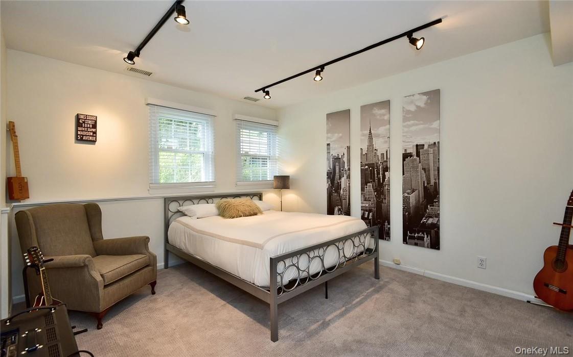 9 Franklin Avenue Rye, NY 10580 - Photo 26 of 35 a spacious bedroom with a bed couch and a window