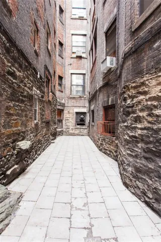 a view of a pathway with a buildings and trees