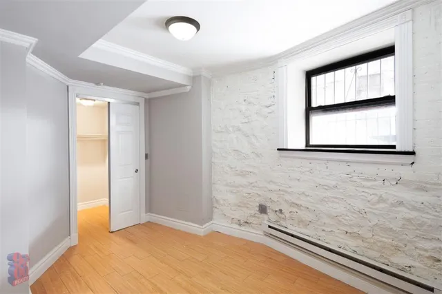 a bathroom with a granite countertop sink and a window