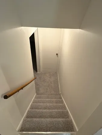 a view of staircase with white walls
