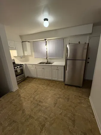 a kitchen with refrigerator and stove