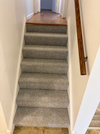 a view of staircase with white walls