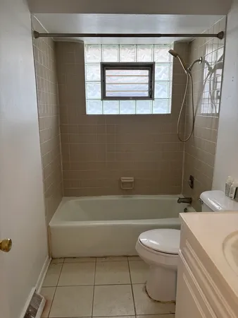 a bathroom with a toilet a sink and bathtub