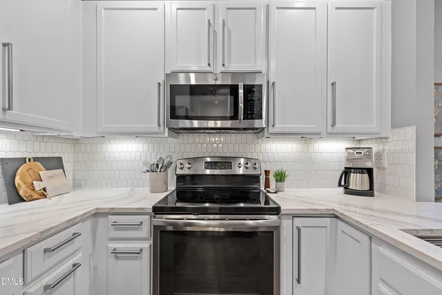 a kitchen with appliances a sink and cabinets