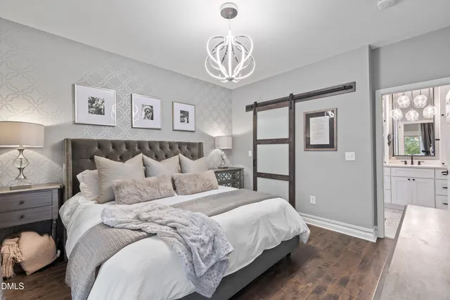 a bedroom with a bed and a chandelier