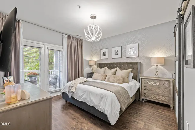 a bedroom with a bed and a large window