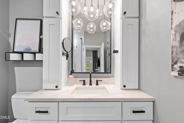 a bathroom with a sink vanity and a mirror
