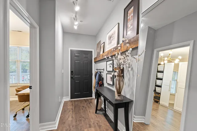 a view of a hallway with wooden floor and entryway