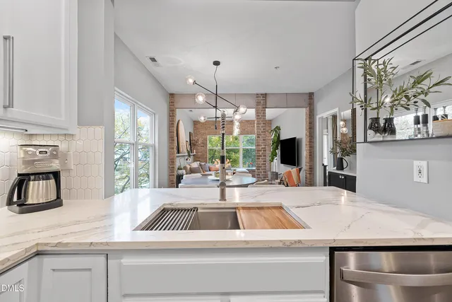 a kitchen with kitchen island a sink appliances and a counter top space
