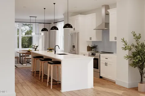 a kitchen with appliances a sink and cabinets