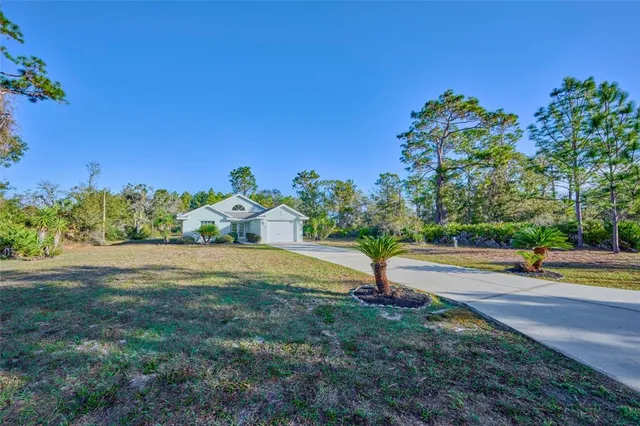 a view of a house with yard and a garden