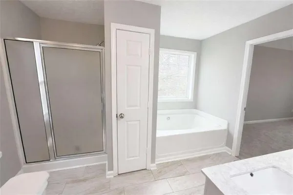 a bathroom with a tub shower and vanity