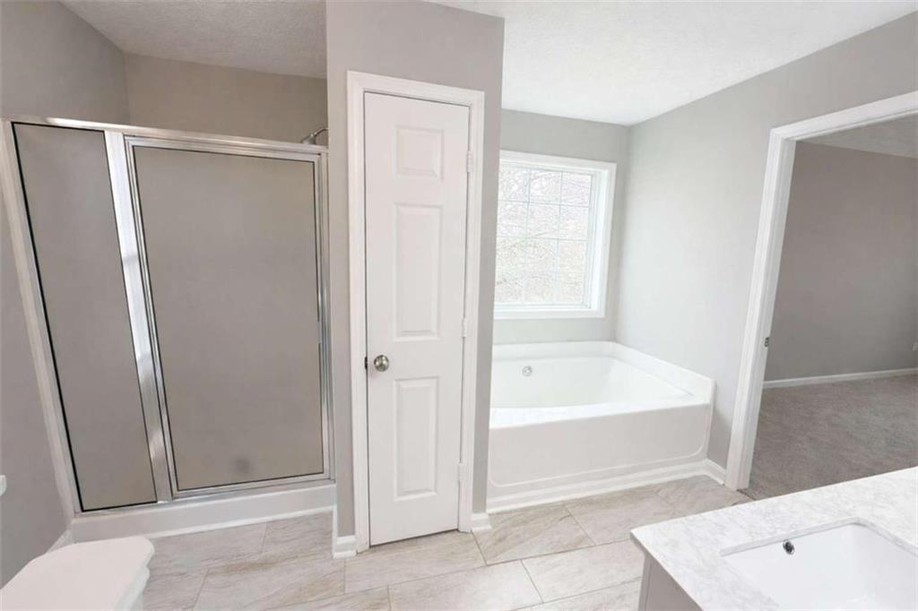 118 Chippewa Run Auburn, GA 30011 - Photo 12 of 26 a bathroom with a tub shower and vanity