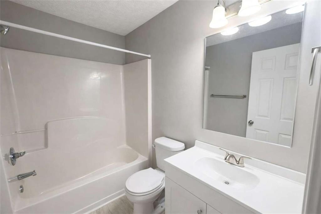 118 Chippewa Run Auburn, GA 30011 - Photo 15 of 26 a bathroom with a bathtub shower sink vanity mirror and toilet