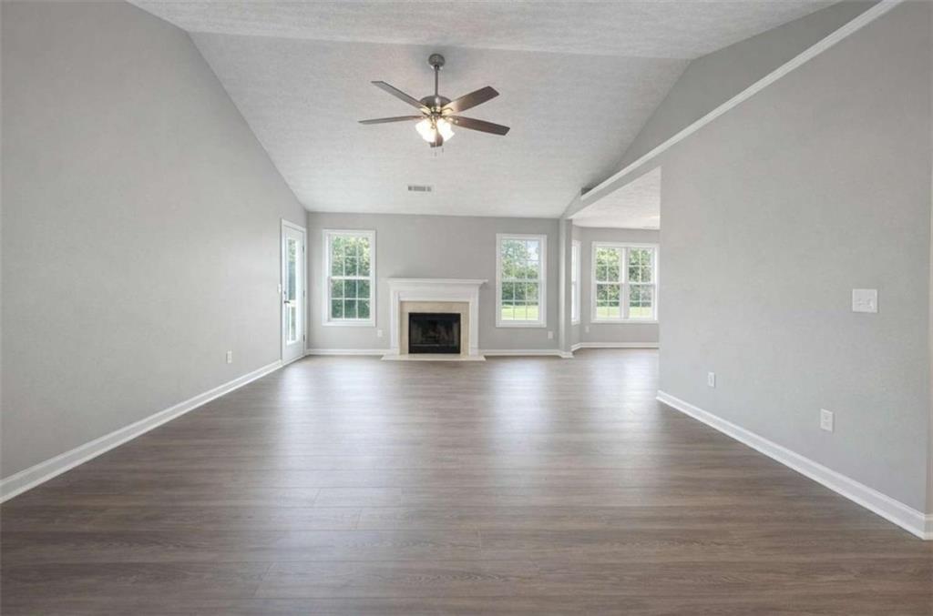 118 Chippewa Run Auburn, GA 30011 - Photo 3 of 26 a view of an empty room with wooden floor and a window