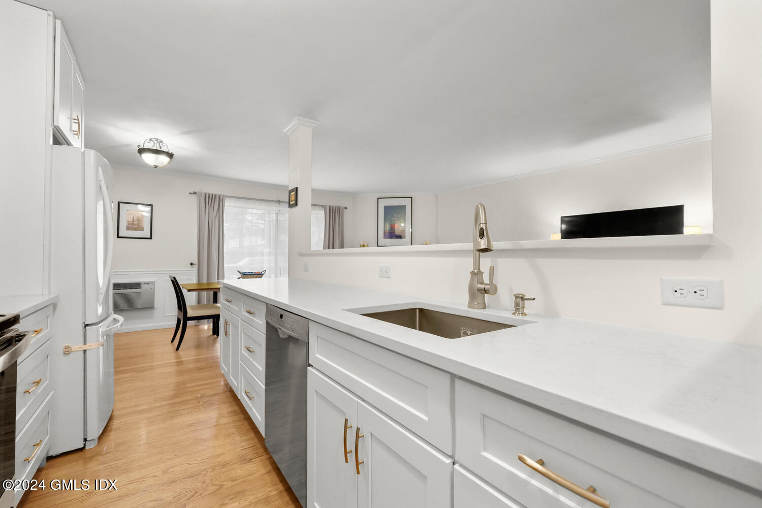 a kitchen with a sink and white cabinets