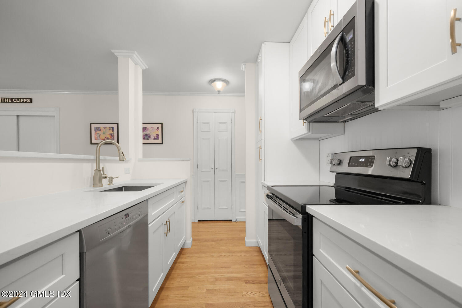 76 Maple Tree Avenue, Unit 3 Stamford, CT 06906 - Photo 13 of 33 a kitchen with stainless steel appliances a sink a stove and cabinets